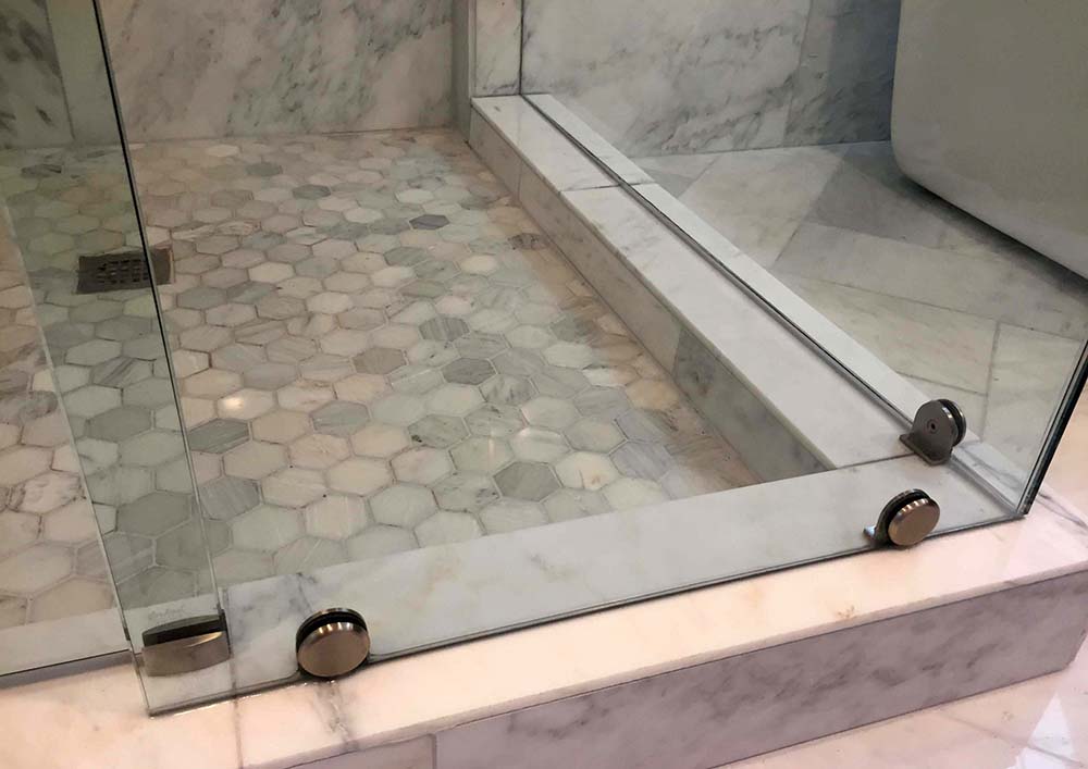 custom glass shower enclosure with clamps