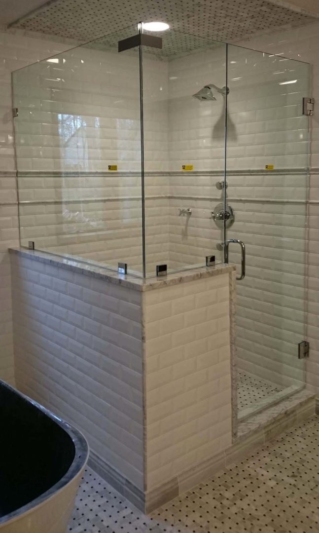 custom glass 90 degree shower enclosure on knee wall with clamps
