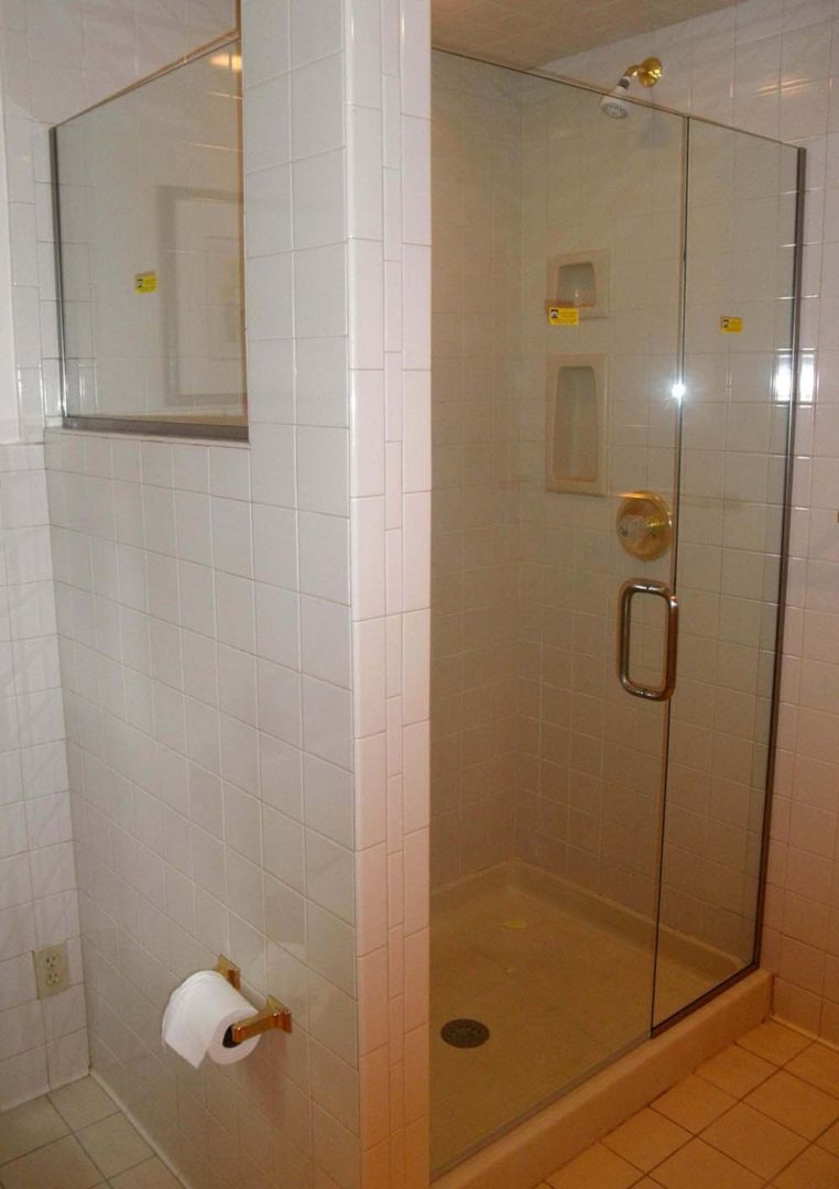 custom glass 90 degree shower enclosure on knee wall with u channel