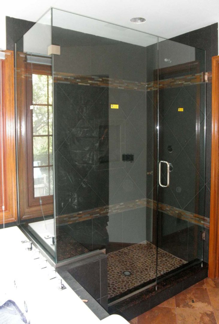 custom glass 90 degree shower enclosure on bench with u channel