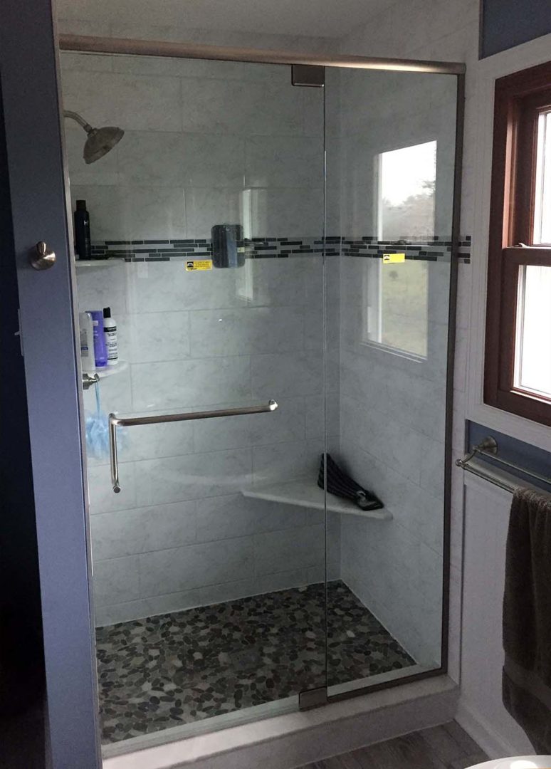 custom glass door and panel shower enclosure with header with u channel