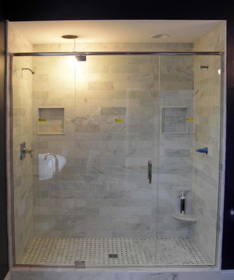 custom glass shower enclosure with header bar with u channel