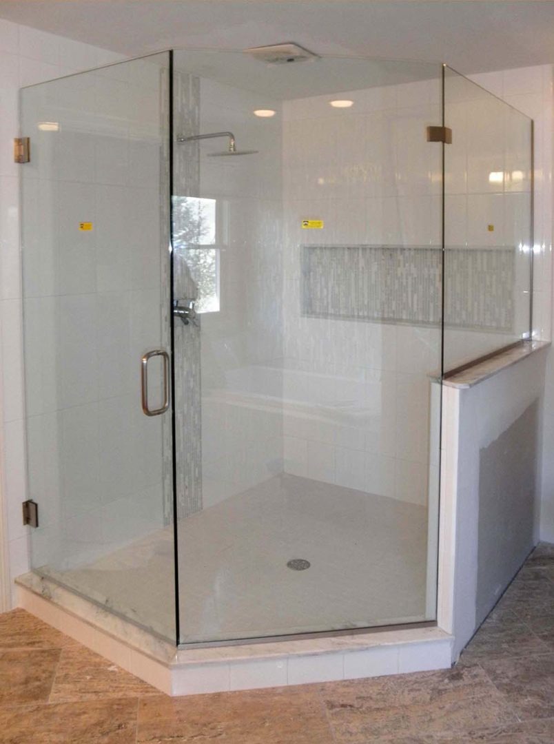 custom glass neo-angle shower enclosure on knee wall with u channel